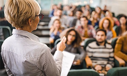 stock image of back of woman teaching to class